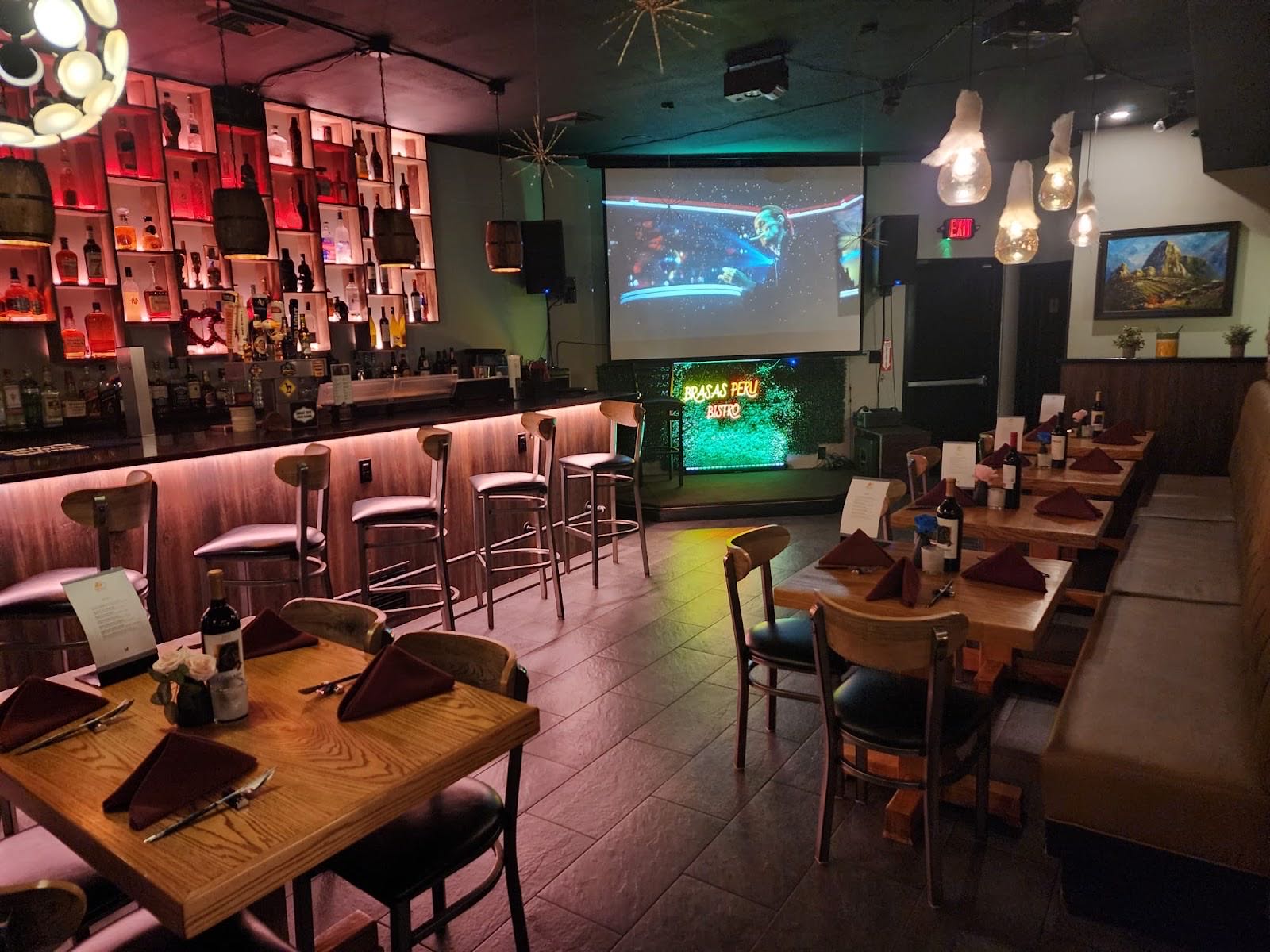 The Brasas dining room with the bar, stage and warm lighting